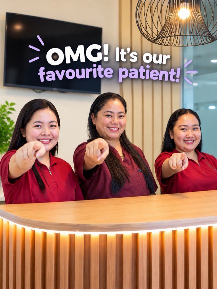 The front desk team welcoming a favorite patient at Home of Dental Aesthetics